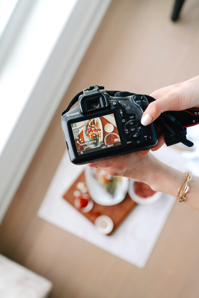 camera taking photo of food on a cutting board for a branding photography shoot in denver