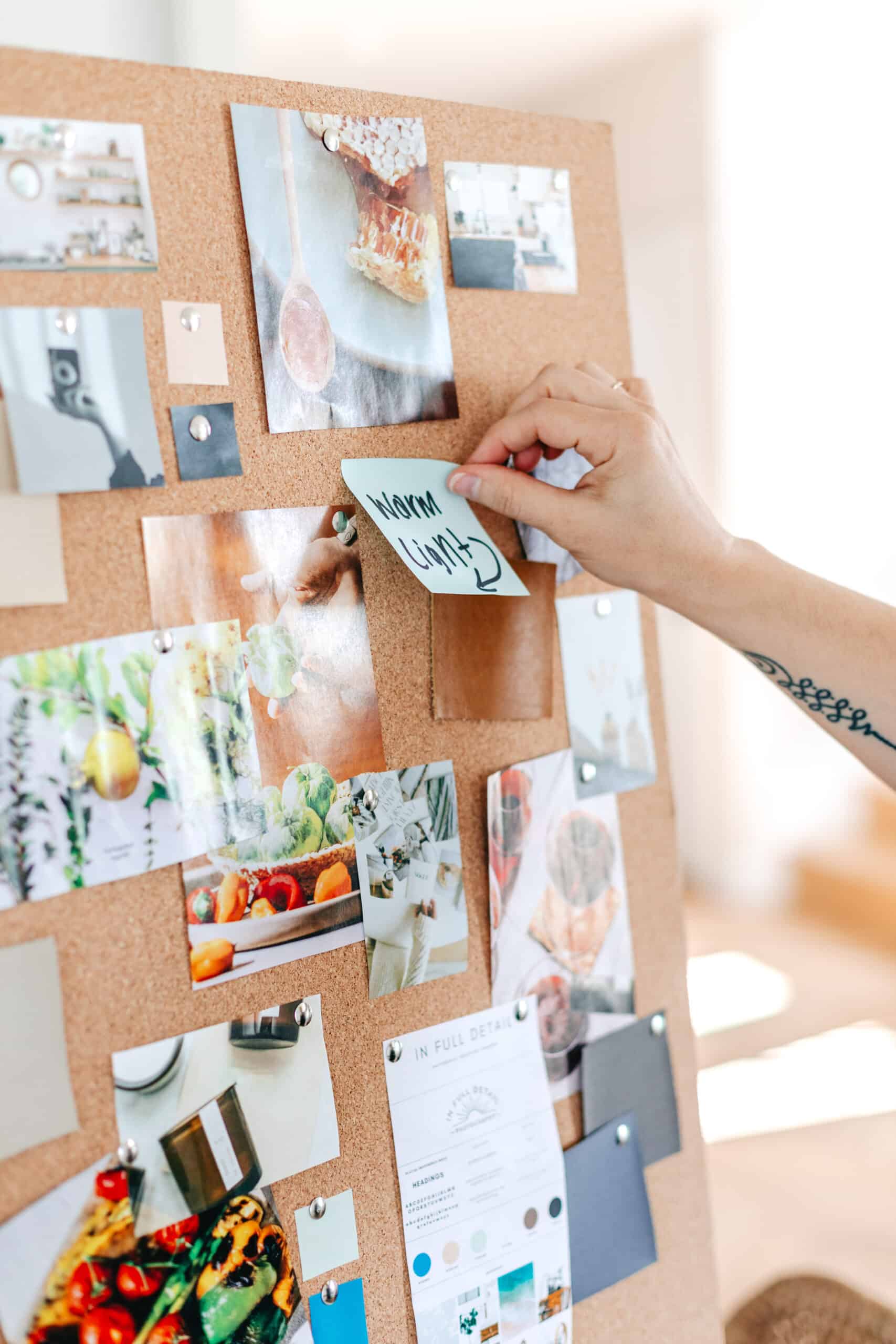 branding photographer planning out the clients mood board and photoshoot on a cork board