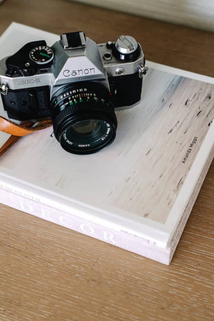 film camera sitting on coffee table book for a san diego branding photoshoot