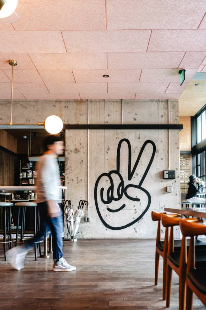 a man with motion blur walking through the lobby of the hoxton hotel in portland oregon for a branding photography shoot